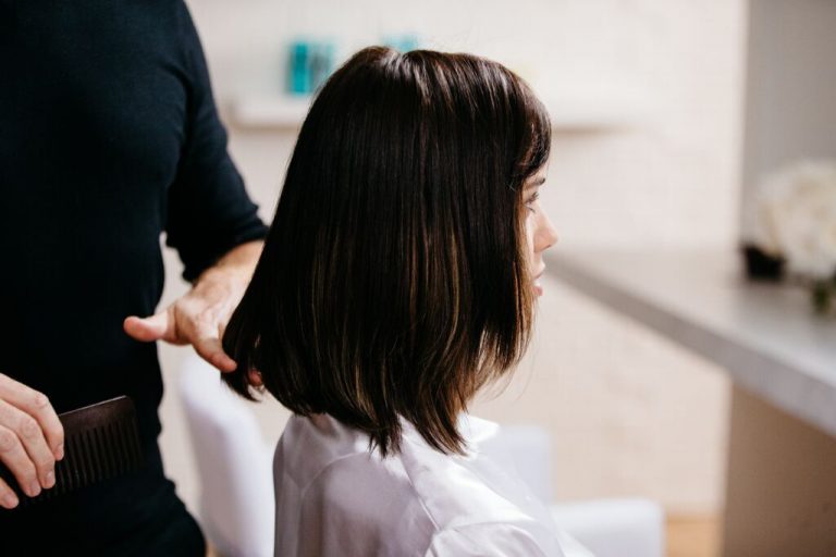 girl getting hair combed in salon moroccanoil. get frequent trims to help avoid damaged hair and split ends