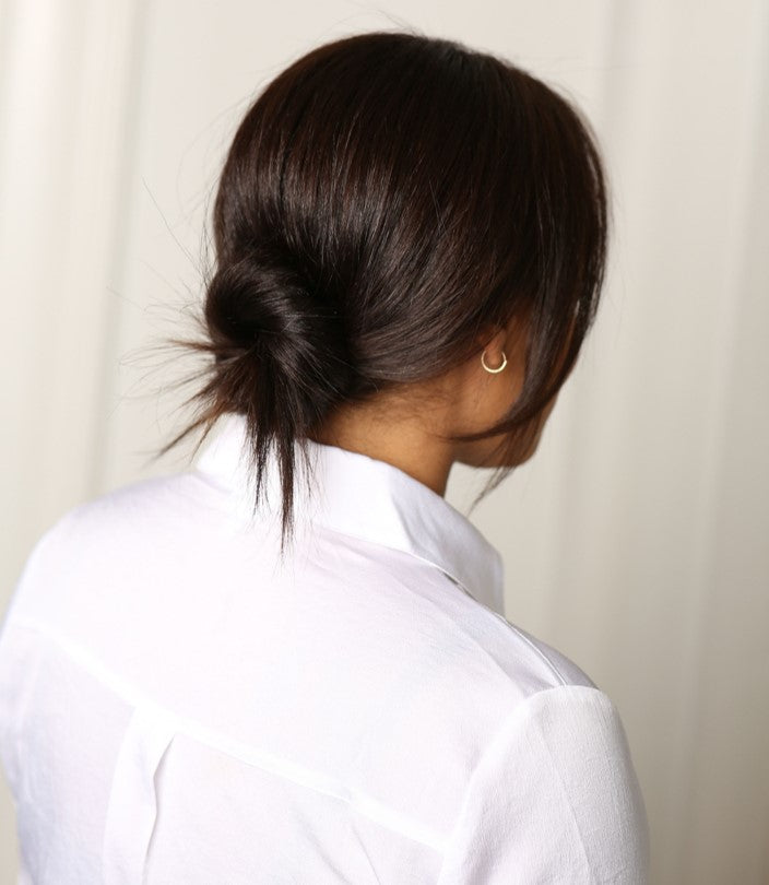 A simple undone bun inspired by Meghan Markle. Find out how to get the look from Moroccanoil.