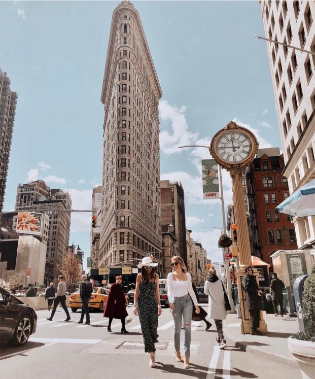 Walking past Flatiron Building New York City